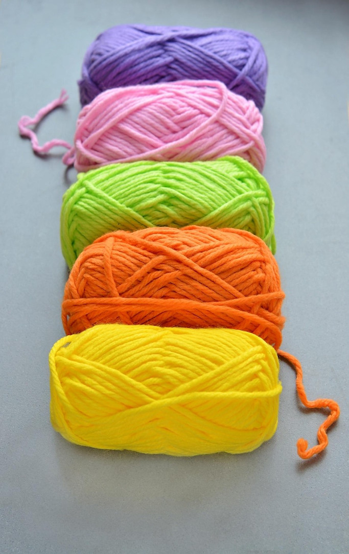 Five skeins of colorful yarn.